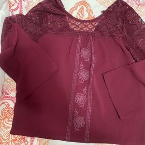 A maroon quarter length sleeve blouse
